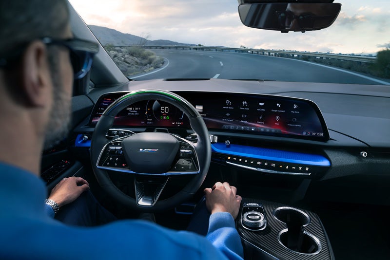 Front View of the 2026 OPTIQ-V Driving Through the Dusk Utilizing its Headlights | Cabrera Hermanos in ARECIBO PR